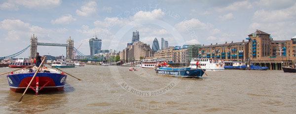 Rowed barges approaching Tower Bridge during the Thames Barge Driving Race 2013