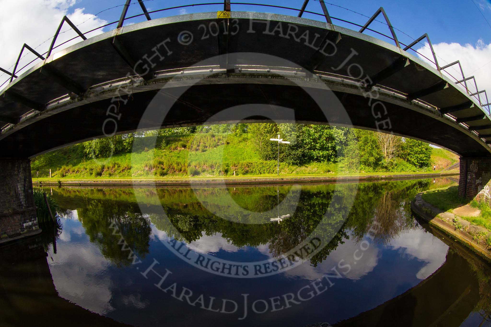 BCN Marathon Challenge 2013: Winson Green Junction Bridge, an old, cast iron bridge with a new, and less attractive, structure attached, seen throuh a wide angle lens, coming from Soho Loop (Winson Green Loop), part of the Old Main Line. In front the New Main Line. In the past the Old Main Line continued on the other side of the New Main Line (the Cape Arm), now,  embankment opposite carries the (water) feeder from Rotton Park Reservoir to the Engine branch..
Birmingham Canal Navigation,


United Kingdom,
on 25 May 2013 at 08:37, image #65