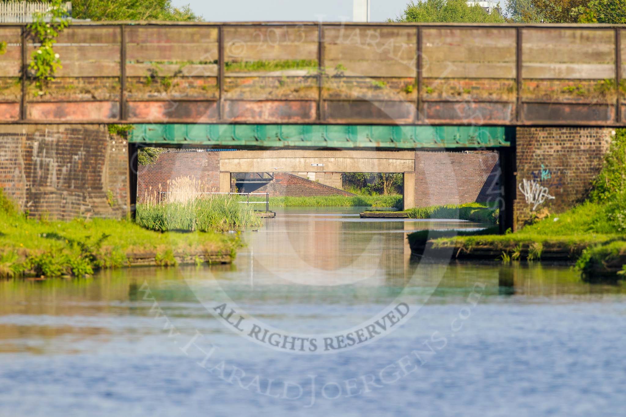 BCN Marathon Challenge 2013: Four bridges in line - the BCN New Main Line, east of Pudding Green Junction. The first is a foot bridge, the second a railway bridge, the third Albion Bridge, carrying Oldbury Road over the canal, and the fourth is a factory bridge well behind Pudding Green Junction. The distances appear compressed as a long lens was used..
Birmingham Canal Navigation,


United Kingdom,
on 25 May 2013 at 18:47, image #297