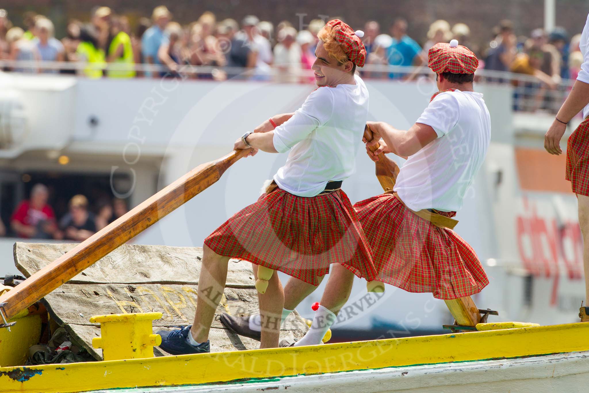 TOW River Thames Barge Driving Race 2013: rowers wearing skirts on the deck of of barge "Hoppy" by GPS Fabrication..
River Thames between Greenwich and Westminster,
London,

United Kingdom,
on 13 July 2013 at 12:36, image #123