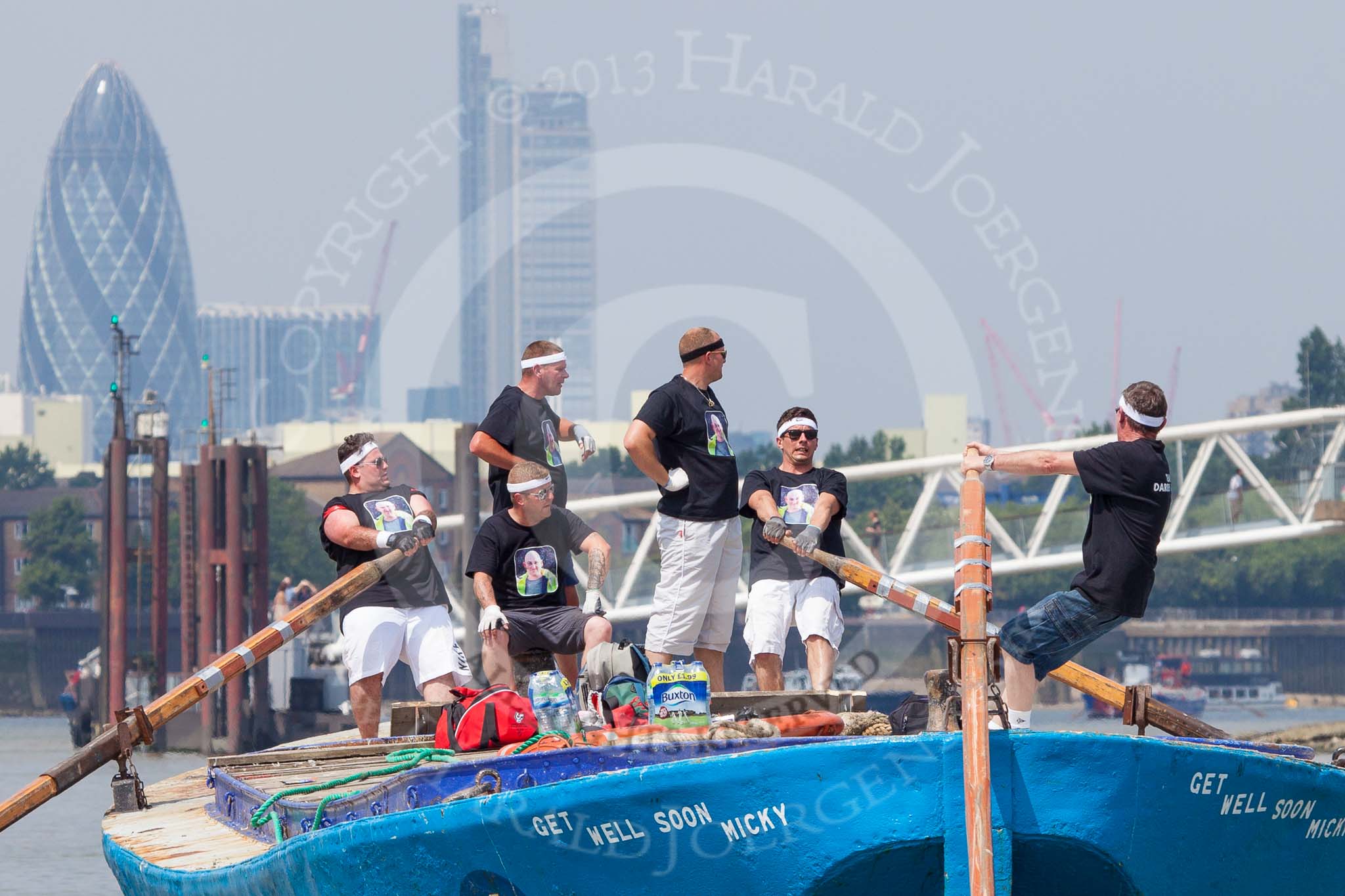 TOW River Thames Barge Driving Race 2013: Rowers on the deck of of barge "Darren Lacey", by Princess Pocahontas, during the race. In the background the skyscrapers of the City of London, including the "Gherkin"..
River Thames between Greenwich and Westminster,
London,

United Kingdom,
on 13 July 2013 at 12:42, image #179