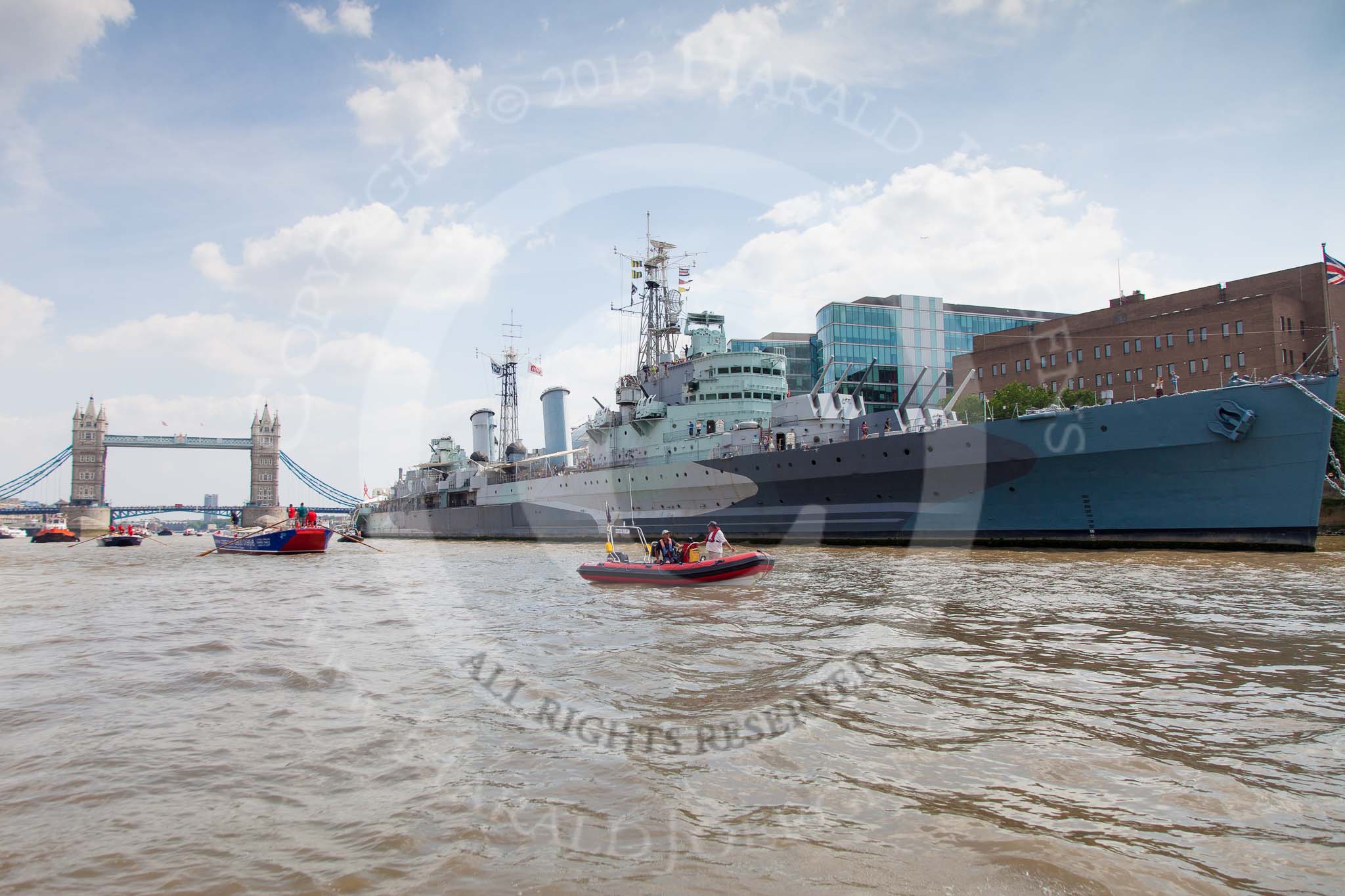 TOW River Thames Barge Driving Race 2013: HMS Belfast, with the Tower Bridge behind, and barge "Steve Faldo" by Capital Pleasure Boats approaching..
River Thames between Greenwich and Westminster,
London,

United Kingdom,
on 13 July 2013 at 13:48, image #397