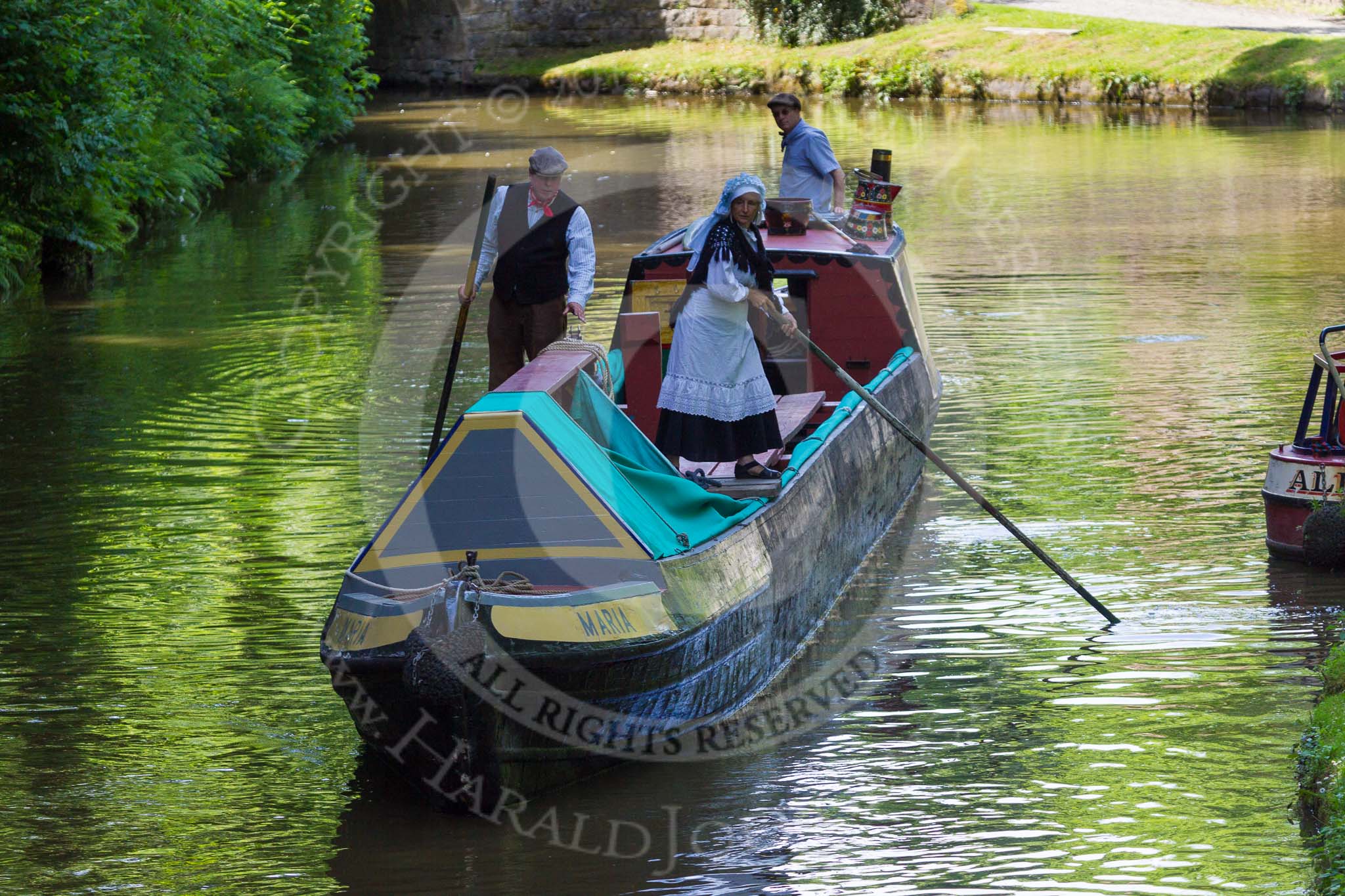: Historic narrowboat is poled towards Marple bottom lock. Without an engine it's either the momentum or manual work that moves the boat into a lock, once the tow line has been released..




on 03 July 2015 at 15:19, image #29