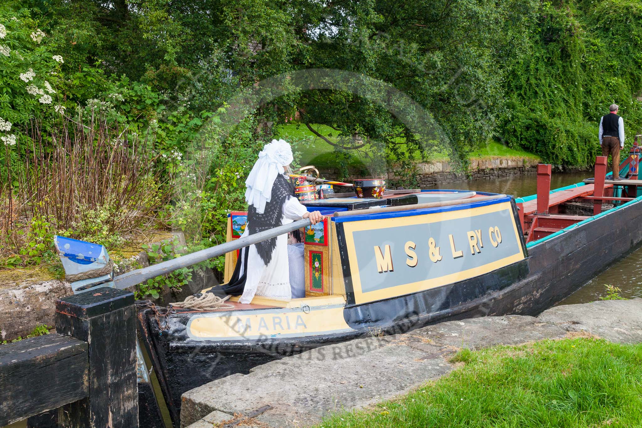 : Barbara Homes (Ashton Packet Boat Co) wearing a traditional bonnet, stears historic narrowboat Maria (built 1854) out of Marple lock 14..




on 03 July 2015 at 18:03, image #93