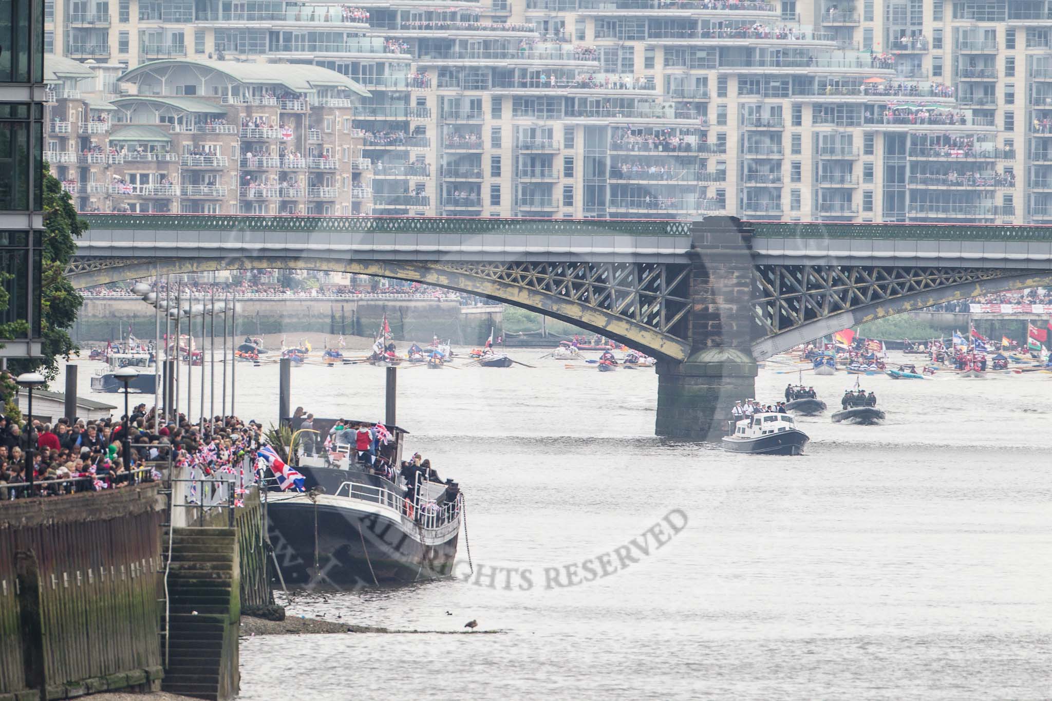 Thames Diamond Jubilee Pageant: Getting ready for the start of the pageant: The man powerd boats are assembled behind Battersea Railway Bridge..
River Thames seen from Battersea Bridge,
London,

United Kingdom,
on 03 June 2012 at 14:03, image #1