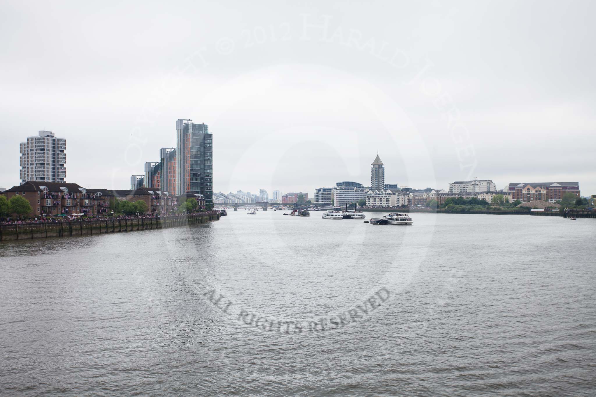 Thames Diamond Jubilee Pageant: View from Battersea Bridge upriver towards Battersea Rail Bridge, the flotilla can be seen behind the bridge through the haze and drizzle..
River Thames seen from Battersea Bridge,
London,

United Kingdom,
on 03 June 2012 at 14:16, image #12