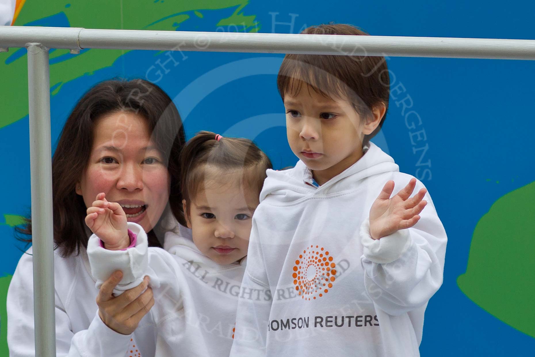 The Lord Mayor's Show 2011: Thomson Reuters (http://www.thomsonreuters.com/), delivering critical information to the financial, legal, tax and accounting, science and media markets. Close-up of a mother with a little girl and a little boy..
Opposite Mansion House, City of London,
London,
-,
United Kingdom,
on 12 November 2011 at 11:16, image #198