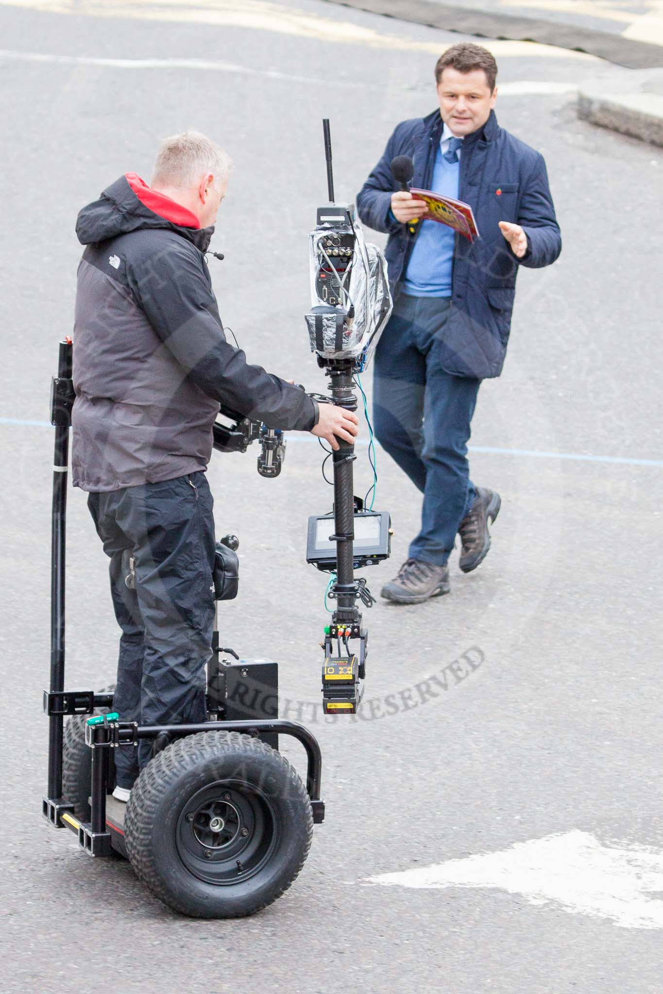 Lord Mayor's Show 2013: The BBC's Chris Hollins and a stedycam-operator on a Segway..
Press stand opposite Mansion House, City of London,
London,
Greater London,
United Kingdom,
on 09 November 2013 at 09:25, image #49