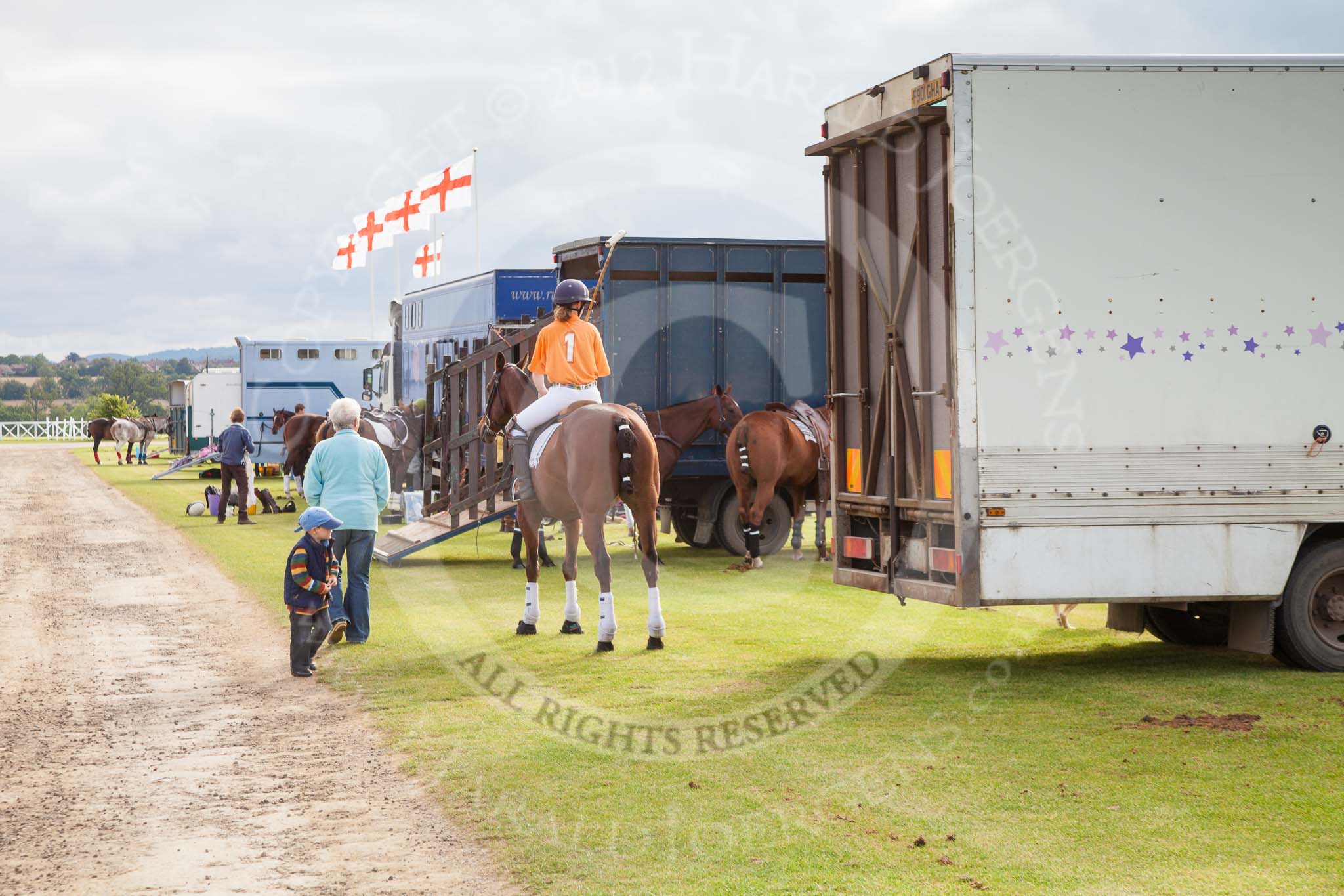 Photo 1209160952315D27982HaraldJoergens DBPC Polo in the Park 2012: The pony line along the Silver Pitch. Already on horseback - No. 1 of the Kangaroos, Jane Kang..
Dallas Burston Polo Club,
Stoneythorpe Estate,
Southam,
Warwickshire,
United Kingdom,
on 16 September 2012 at 09:52, image #17