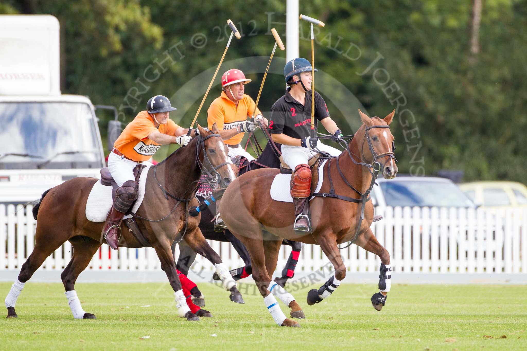 DBPC Polo in the Park 2012: Kangaroos #3 player Huw Beavan, #2, Steve Radford, and Marston's #2, Miles Marlow-Thomas..
Dallas Burston Polo Club,
Stoneythorpe Estate,
Southam,
Warwickshire,
United Kingdom,
on 16 September 2012 at 10:43, image #47