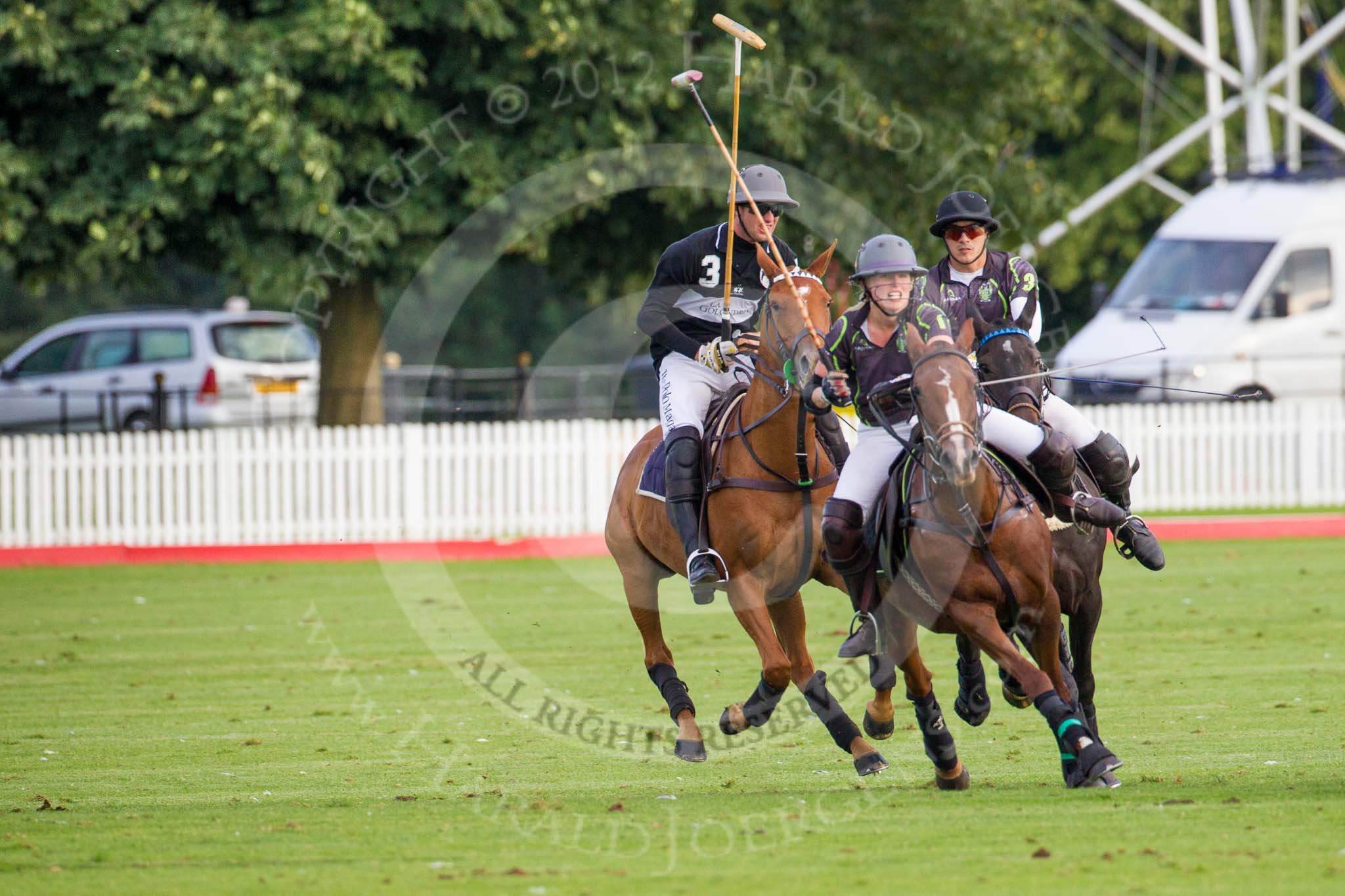 DBPC Polo in the Park 2012: Rigby & Rigby #1, Jenny Rigby, and #3, Tomy Iriarte, followed by La Golondrina #3, Pedro Harrison..
Dallas Burston Polo Club,
Stoneythorpe Estate,
Southam,
Warwickshire,
United Kingdom,
on 16 September 2012 at 17:43, image #290