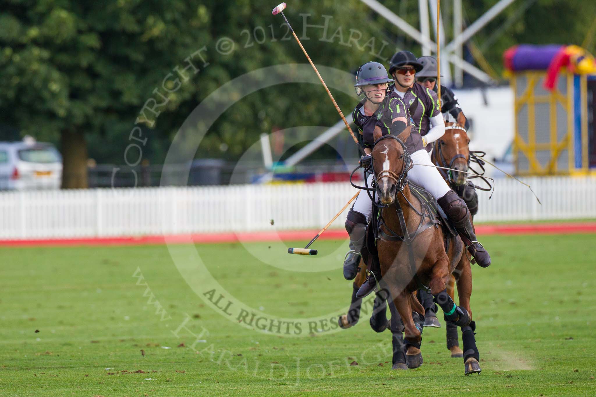 Photo 1209161743141D47238HaraldJoergens DBPC Polo in the Park 2012: Rigby & Rigby #1, Jenny Rigby, and #3, Tomy Iriarte, followed by La Golondrina #3, Pedro Harrison..
Dallas Burston Polo Club,
Stoneythorpe Estate,
Southam,
Warwickshire,
United Kingdom,
on 16 September 2012 at 17:43, image #291