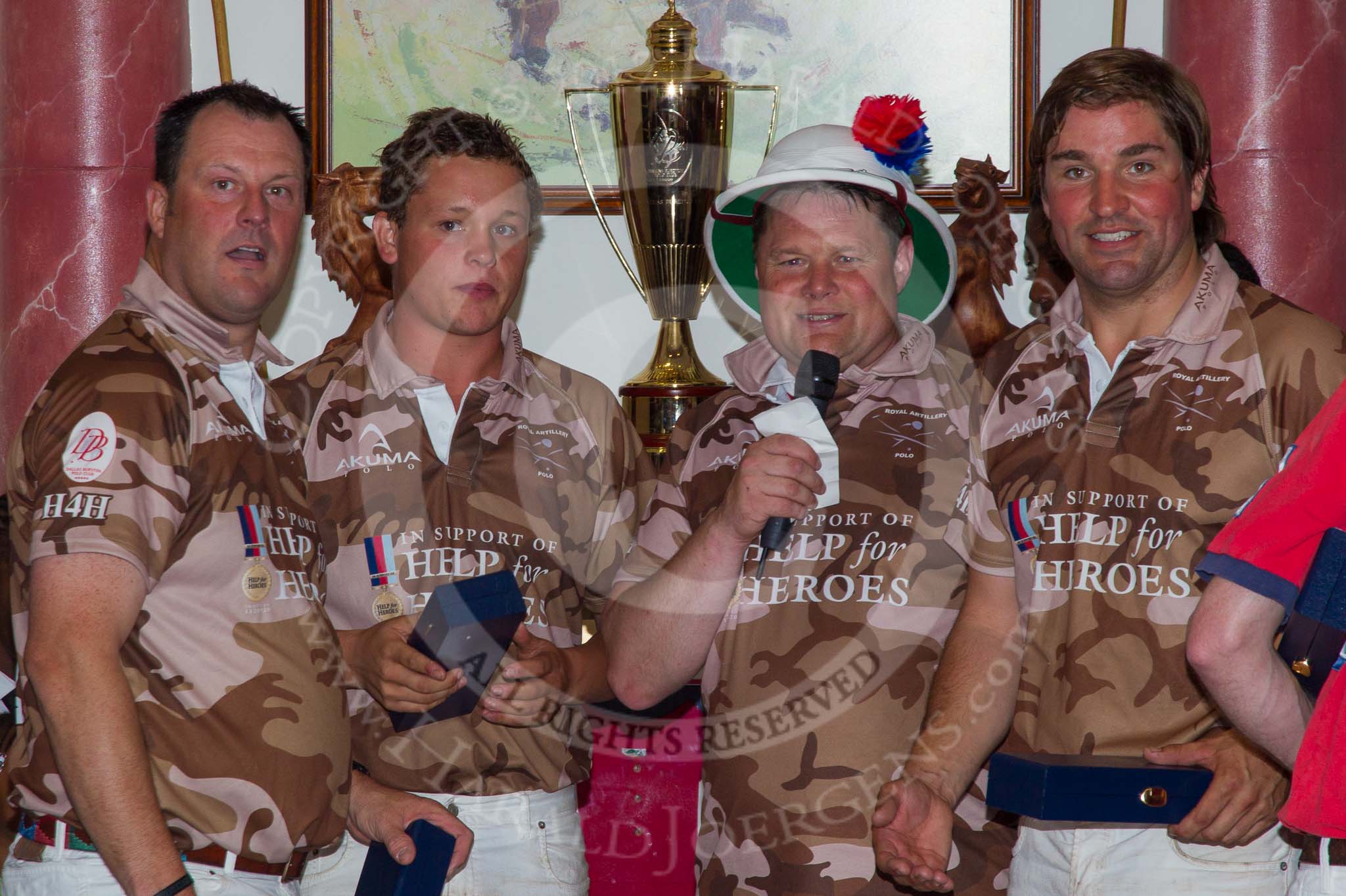 DBPC Polo in the Park 2012: Major Andy Wood, Alex Vent, Bombardier Richard Morris, and Karl Ude-Martinez for the Royal Artillery polo team at the price giving in the clubhouse..
Dallas Burston Polo Club,
Stoneythorpe Estate,
Southam,
Warwickshire,
United Kingdom,
on 16 September 2012 at 19:19, image #354