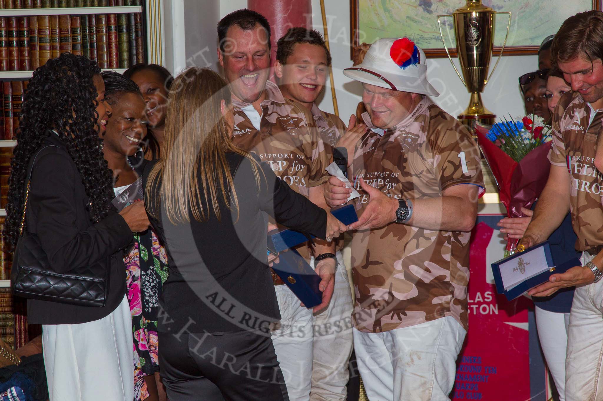 DBPC Polo in the Park 2012: Major Andy Wood, Alex Vent, Bombardier Richard Morris, and Karl Ude-Martinez for the Royal Artillery polo team at the price giving in the clubhouse - DBPC PR Manager April Baron-Harrison handing over the prices..
Dallas Burston Polo Club,
Stoneythorpe Estate,
Southam,
Warwickshire,
United Kingdom,
on 16 September 2012 at 19:19, image #356