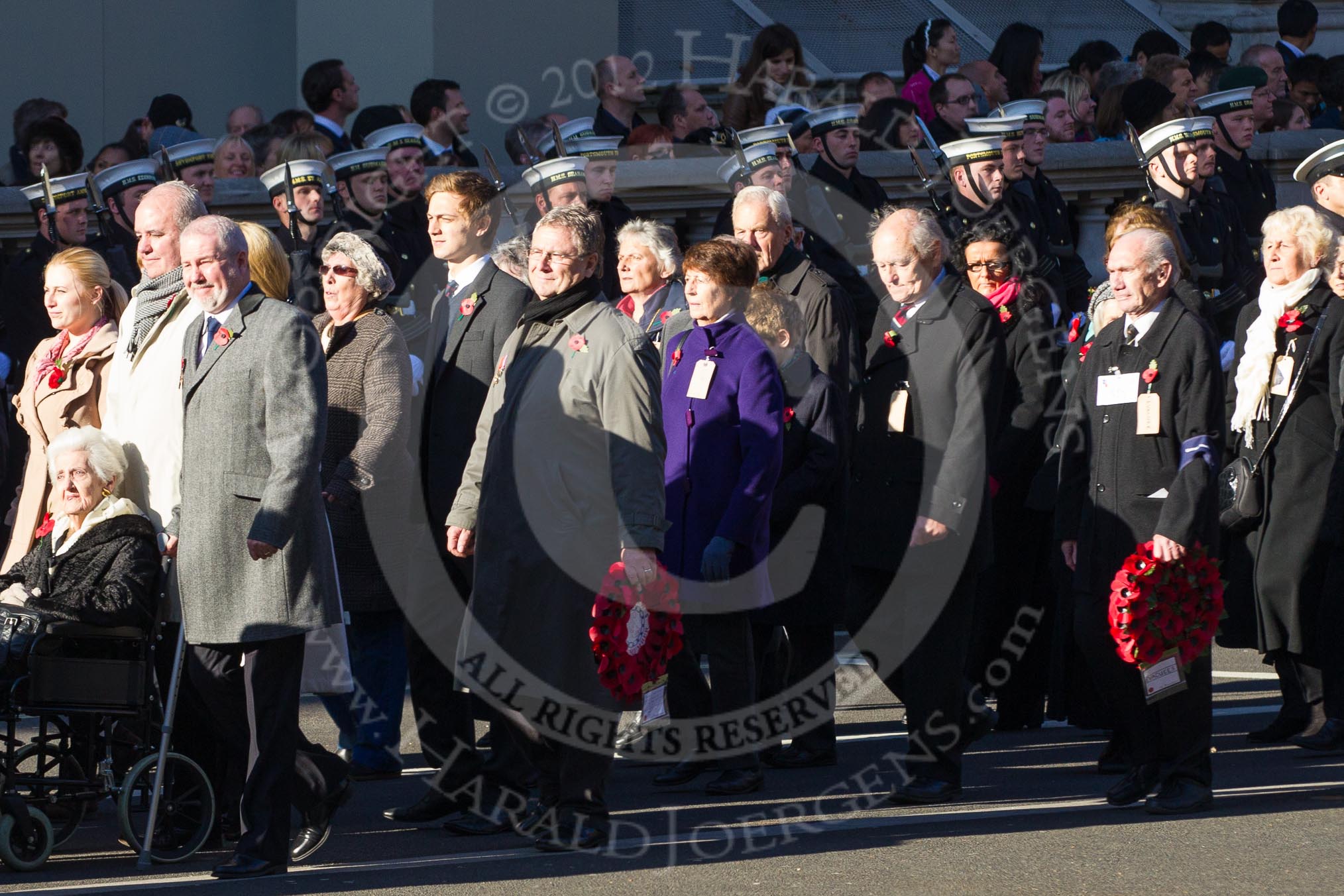 Remembrance Sunday 2012 Cenotaph March Past: Group M5  - Children of the Far East Prisoners of War and M6 - Evacuees Reunion Association..
Whitehall, Cenotaph,
London SW1,

United Kingdom,
on 11 November 2012 at 12:09, image #1460