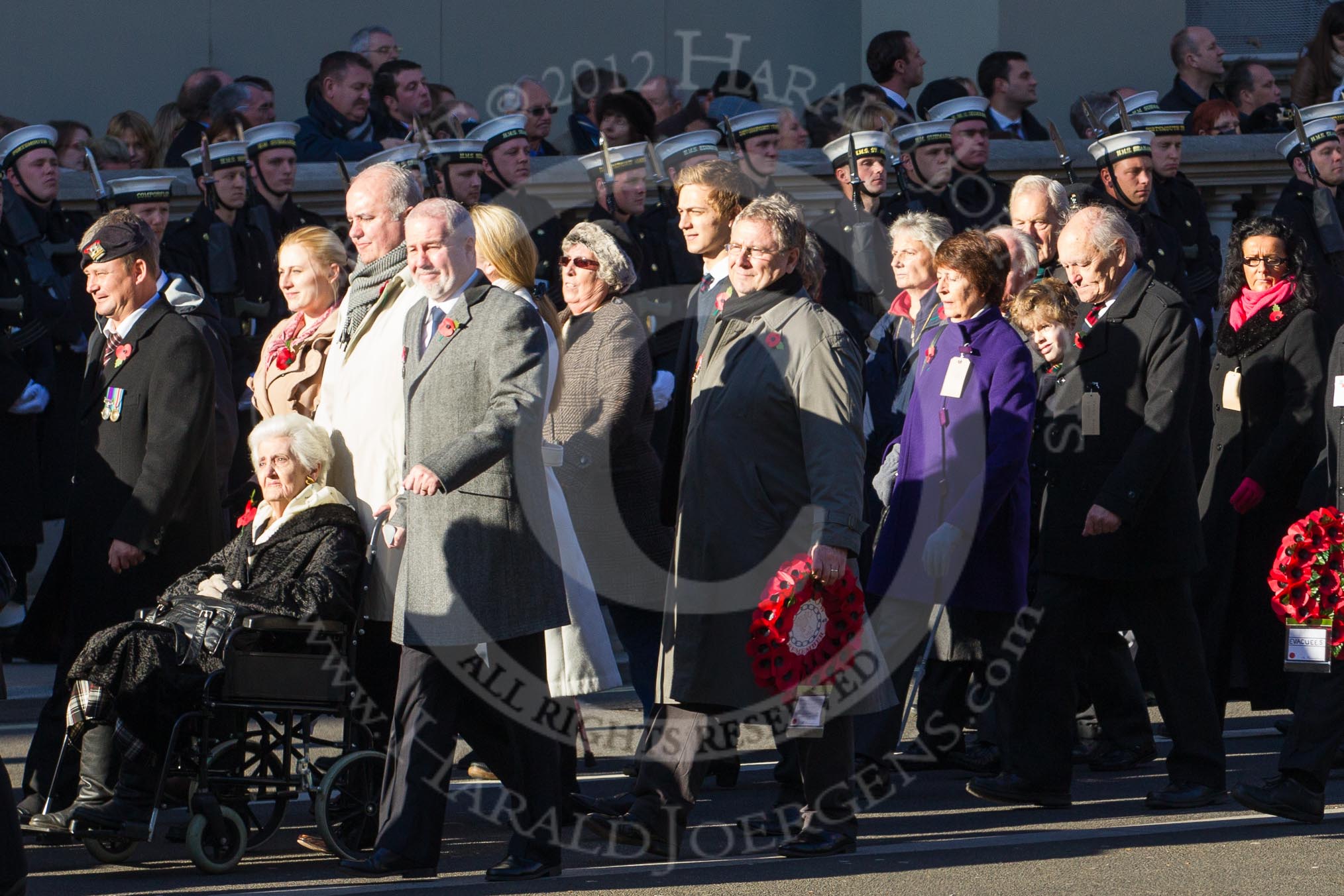 Remembrance Sunday 2012 Cenotaph March Past: Group M5  - Children of the Far East Prisoners of War and M6 - Evacuees Reunion Association..
Whitehall, Cenotaph,
London SW1,

United Kingdom,
on 11 November 2012 at 12:09, image #1461