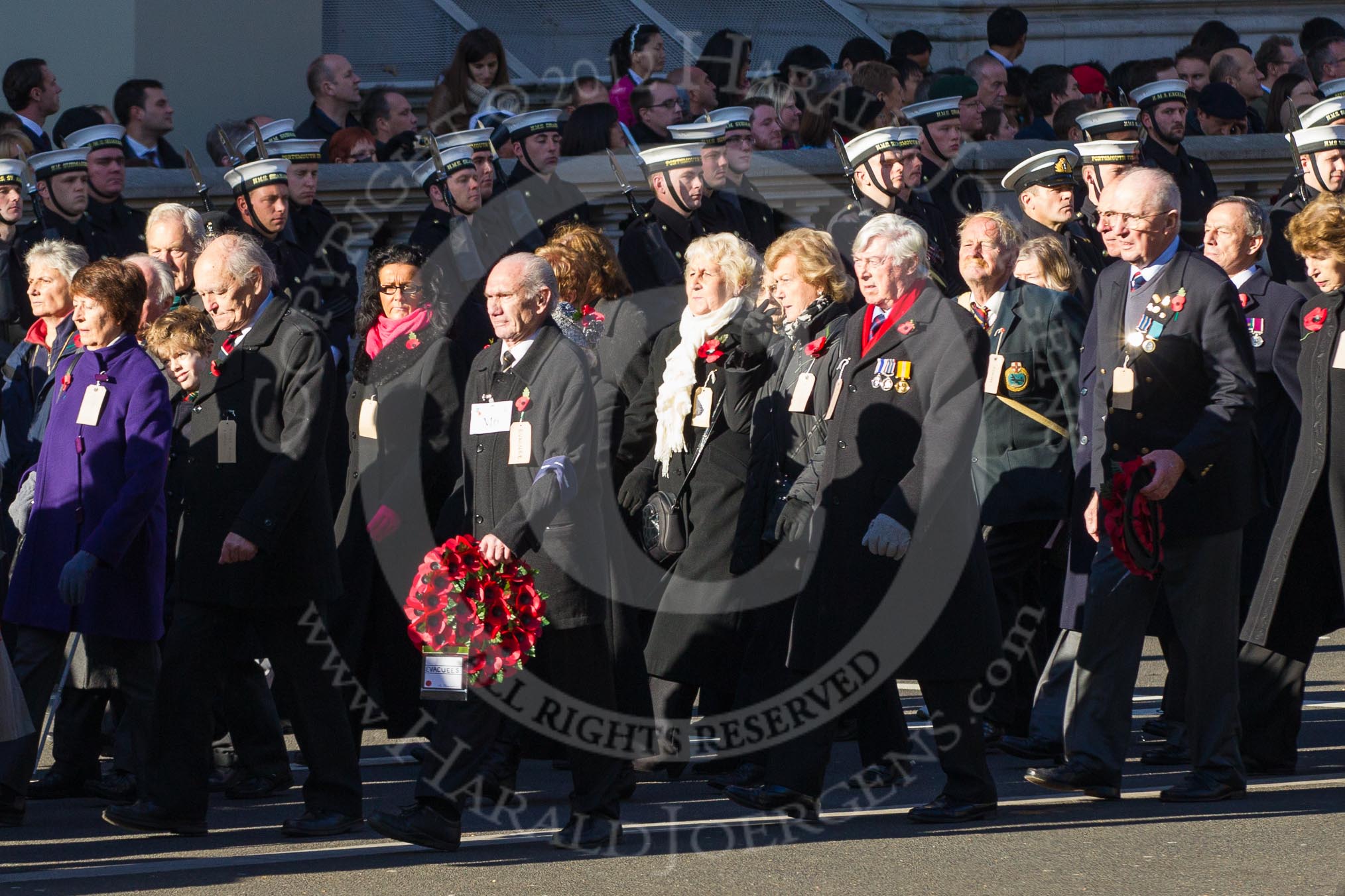 Remembrance Sunday 2012 Cenotaph March Past: Group M5  - Children of the Far East Prisoners of War and M6 - Evacuees Reunion Association..
Whitehall, Cenotaph,
London SW1,

United Kingdom,
on 11 November 2012 at 12:09, image #1462