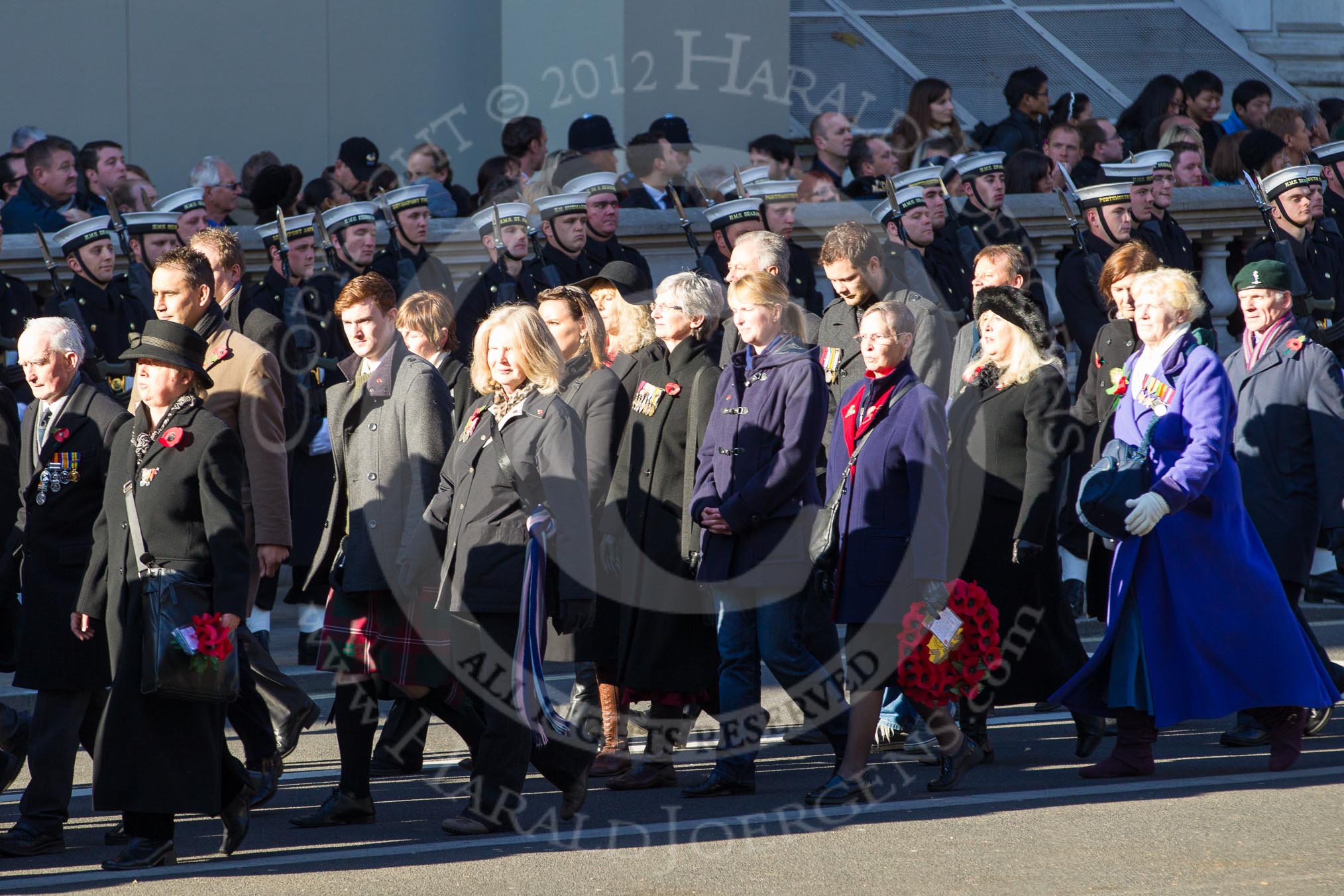 Remembrance Sunday 2012 Cenotaph March Past: Group M23 - Civilians Representing Families..
Whitehall, Cenotaph,
London SW1,

United Kingdom,
on 11 November 2012 at 12:12, image #1588