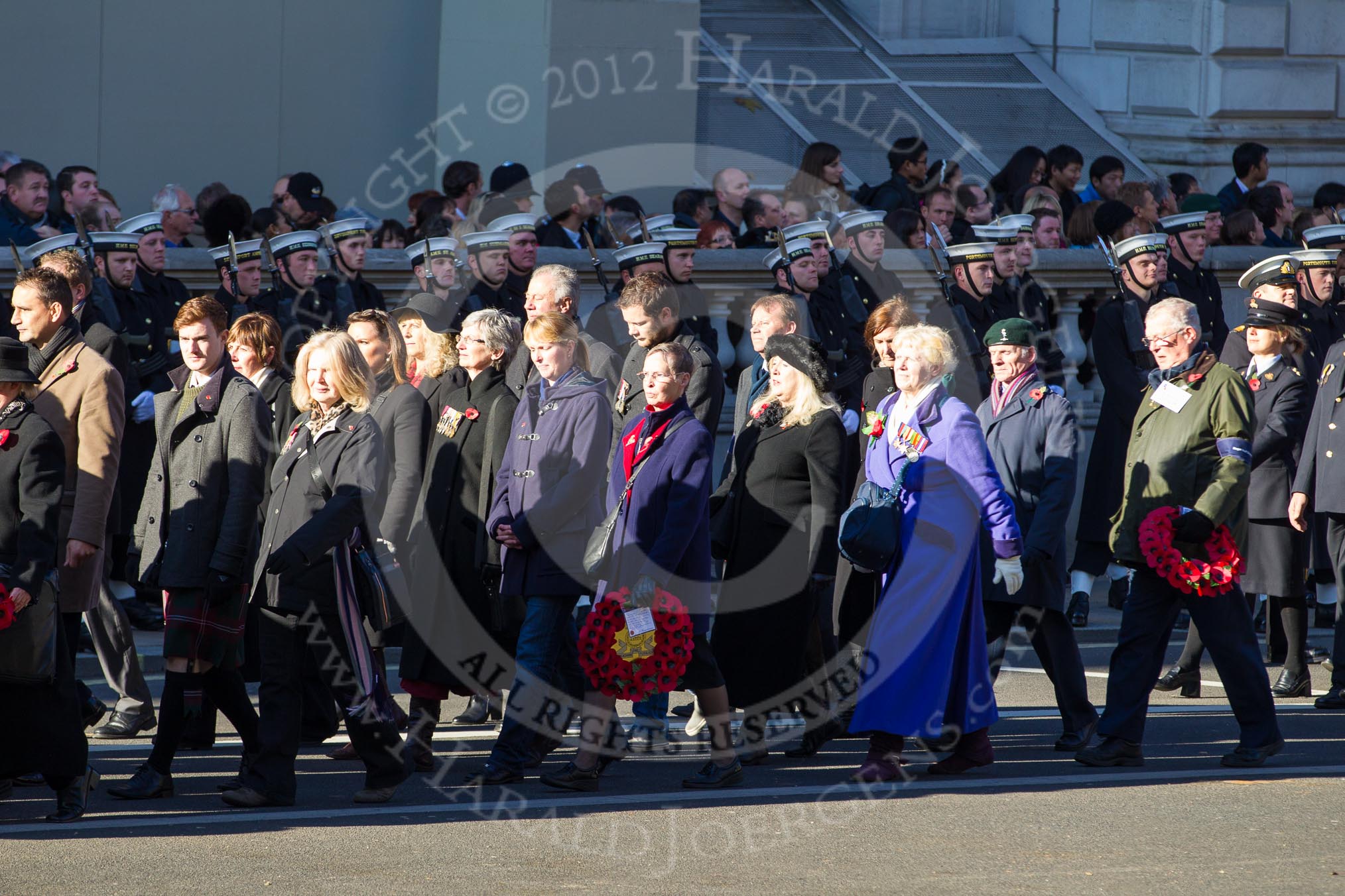 Remembrance Sunday 2012 Cenotaph March Past: Group M23 - Civilians Representing Families and M24 - Royal Mail Group Ltd..
Whitehall, Cenotaph,
London SW1,

United Kingdom,
on 11 November 2012 at 12:12, image #1589