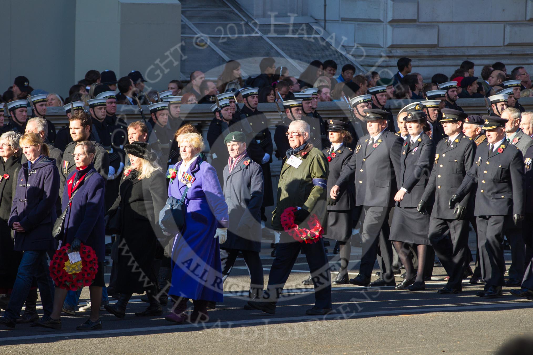 Remembrance Sunday 2012 Cenotaph March Past: Group M23 - Civilians Representing Families, M24 - Royal Mail Group Ltd, and M25 - Royal Society for the Prevention of Cruelty to Animals..
Whitehall, Cenotaph,
London SW1,

United Kingdom,
on 11 November 2012 at 12:12, image #1590