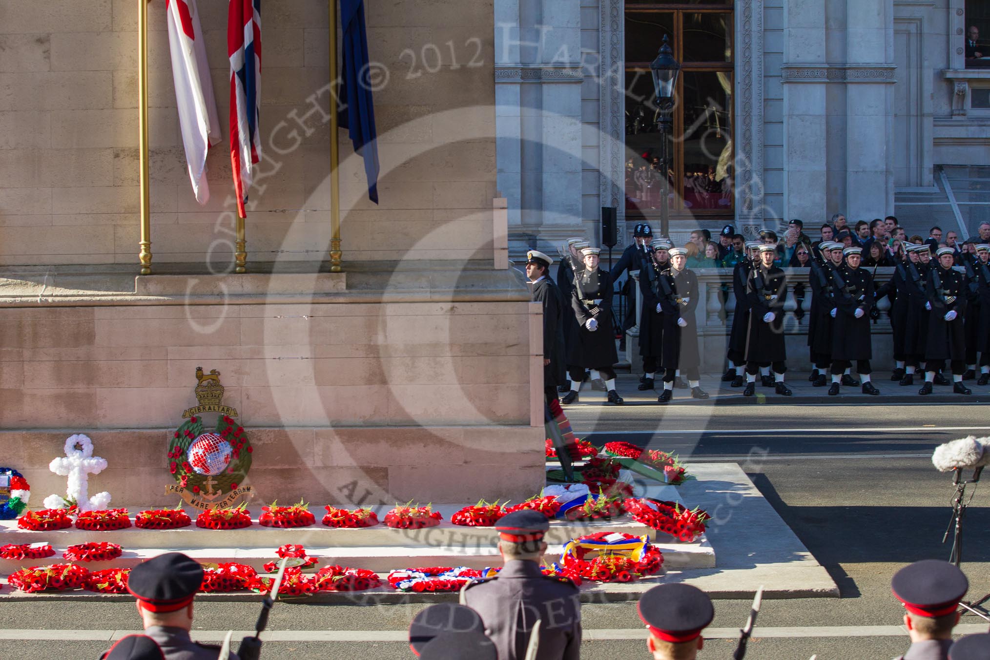 Remembrance Sunday 2012 Cenotaph March Past: The southern side of the Cenotaph after the March Past, with the bright red of all the wreaths. Behind the lines of Royal Marines standing in front of the Foreign- and Commonweatlt Office building..
Whitehall, Cenotaph,
London SW1,

United Kingdom,
on 11 November 2012 at 12:16, image #1771