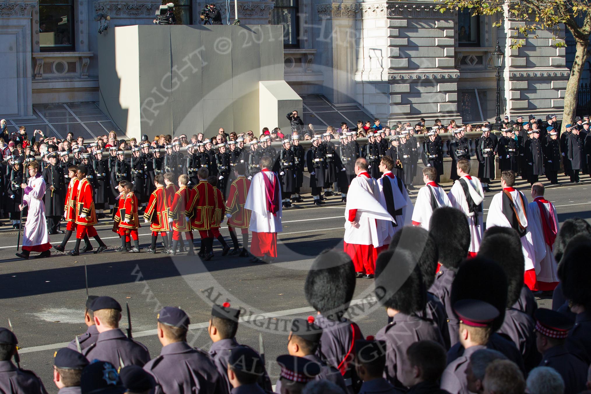 Following the Forces Chaplain and the Bishop of London, Cross Bearer, the 10 Children of the Chapel Royal, and the 6 Gentlemen-in-Ordinary ares leaving Whitehall towards the Foreign- and Commonwealth Office building.