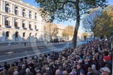 The eastern side of Whitehallon the morning of Remembrance Sunday. The street is cordoned off, large crowds are waiting on the pavement.