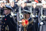The golden cross with the poppies carried by the cross bearer, out of focus, and HRH the Duke of Edinburgh and HRH The Duke of York.