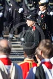 HM The Queen and, behind and out of focus, the Princess Royal, whist Beethoven's Funeral March is played.