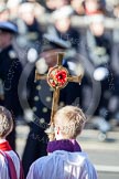 The golden cross with the poppies held by the cross bearer during the service by the Bishop of London.