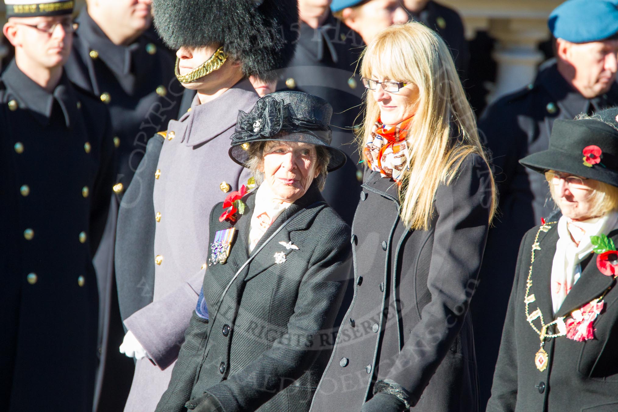 Remembrance Sunday Cenotaph March Past 2013: D1 - War Widows Association. The lady with the long blond hair is Lesley-Ann George-Taylor, Chairman of the Royal Navy and Royal Marines Widows Association. On the left, with the black hat, is the WWA Committee member Marjory Dodson..
Press stand opposite the Foreign Office building, Whitehall, London SW1,
London,
Greater London,
United Kingdom,
on 10 November 2013 at 11:38, image #17