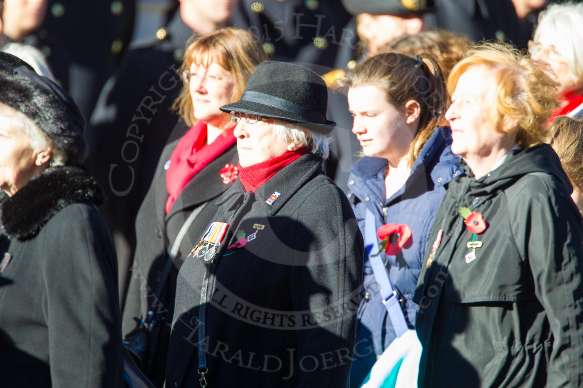 Remembrance Sunday Cenotaph March Past 2013: D1 - War Widows Association. The War Widows' Association exisits to improve the conditions of all War Widow/ers in the United Kingdom. The Association formed in 1971 following an article in a Sunday newspaper that highlighted the plight of Britain’s “forgotten women”. The Association gained charitable status in 1991 and continues to campaign against injustice..
Press stand opposite the Foreign Office building, Whitehall, London SW1,
London,
Greater London,
United Kingdom,
on 10 November 2013 at 11:38, image #21