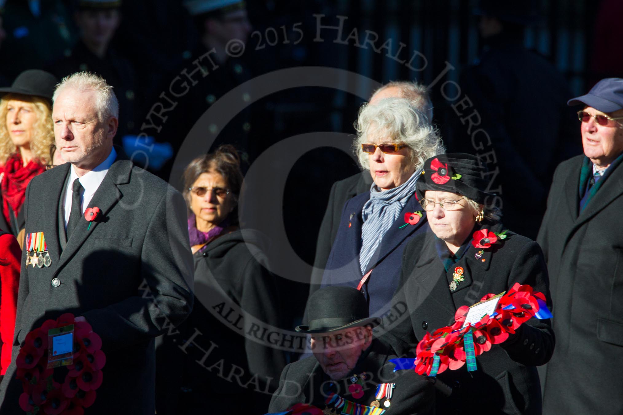 Remembrance Sunday Cenotaph March Past 2013: M23 - Civilians Representing Families..
Press stand opposite the Foreign Office building, Whitehall, London SW1,
London,
Greater London,
United Kingdom,
on 10 November 2013 at 12:12, image #2058