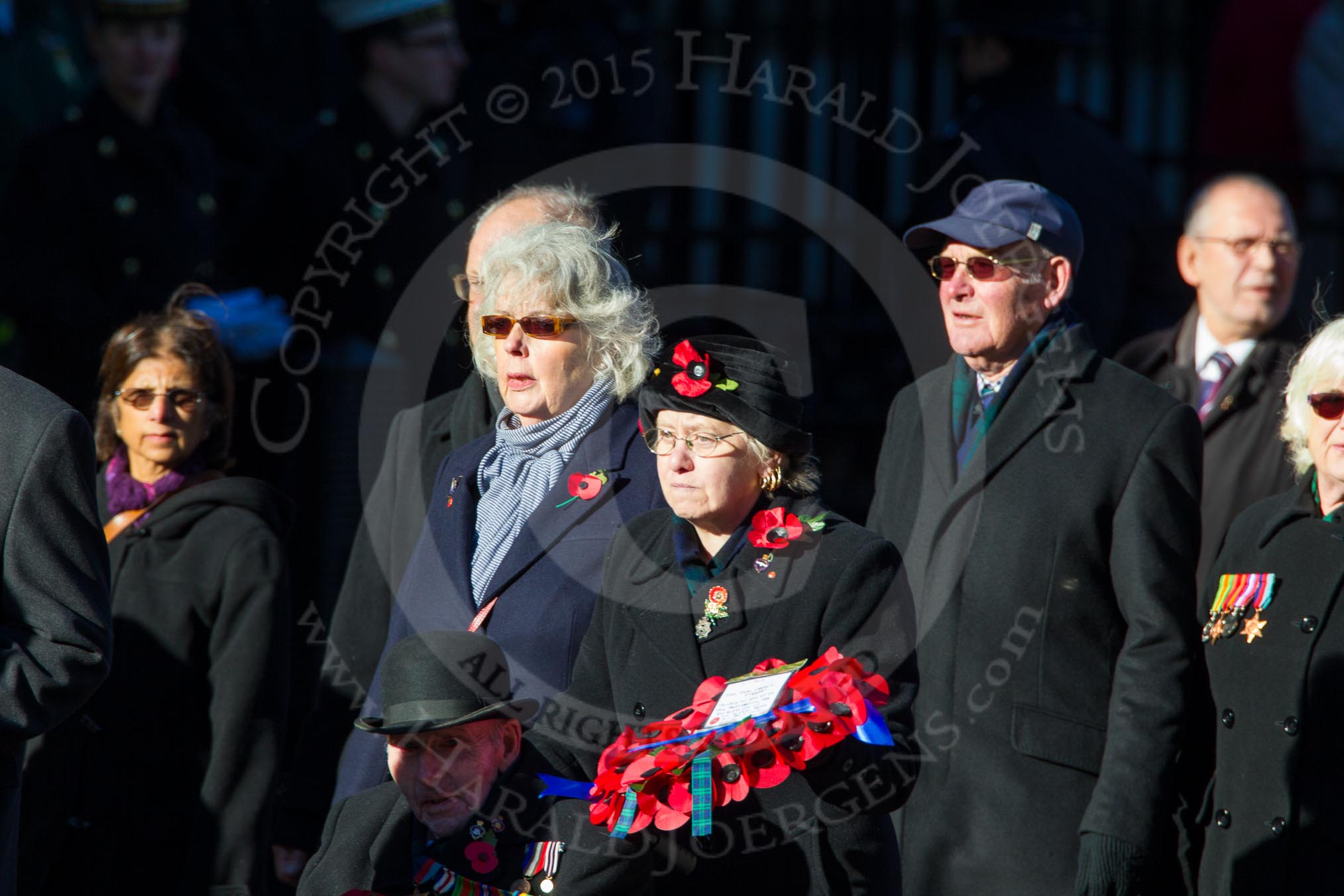 Remembrance Sunday Cenotaph March Past 2013: M23 - Civilians Representing Families..
Press stand opposite the Foreign Office building, Whitehall, London SW1,
London,
Greater London,
United Kingdom,
on 10 November 2013 at 12:12, image #2059