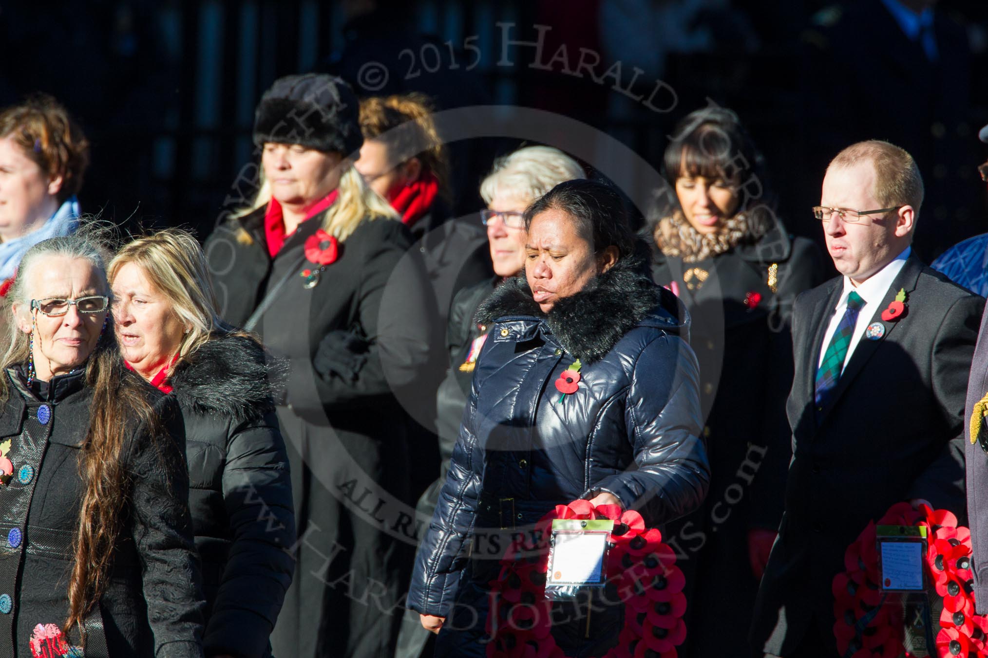 Remembrance Sunday Cenotaph March Past 2013: M23 - Civilians Representing Families..
Press stand opposite the Foreign Office building, Whitehall, London SW1,
London,
Greater London,
United Kingdom,
on 10 November 2013 at 12:12, image #2062