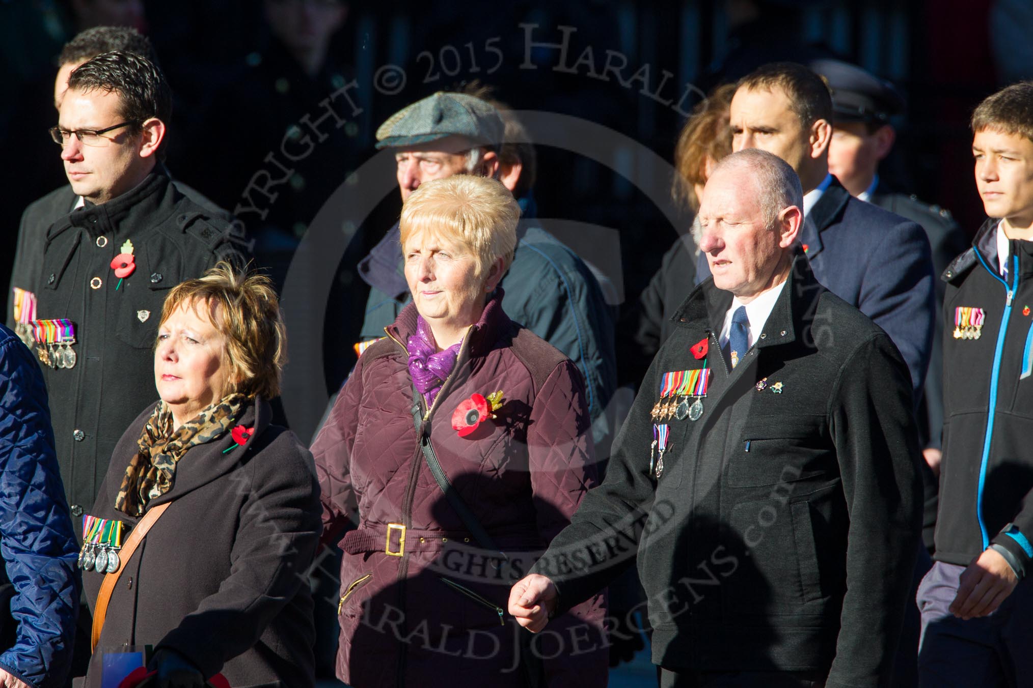 Remembrance Sunday Cenotaph March Past 2013: M23 - Civilians Representing Families..
Press stand opposite the Foreign Office building, Whitehall, London SW1,
London,
Greater London,
United Kingdom,
on 10 November 2013 at 12:12, image #2066