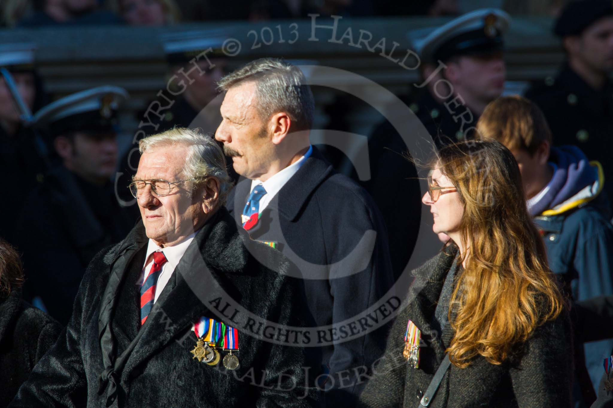 Remembrance Sunday at the Cenotaph in London 2014: Group M23 - Civilians Representing Families.
Press stand opposite the Foreign Office building, Whitehall, London SW1,
London,
Greater London,
United Kingdom,
on 09 November 2014 at 12:17, image #2148