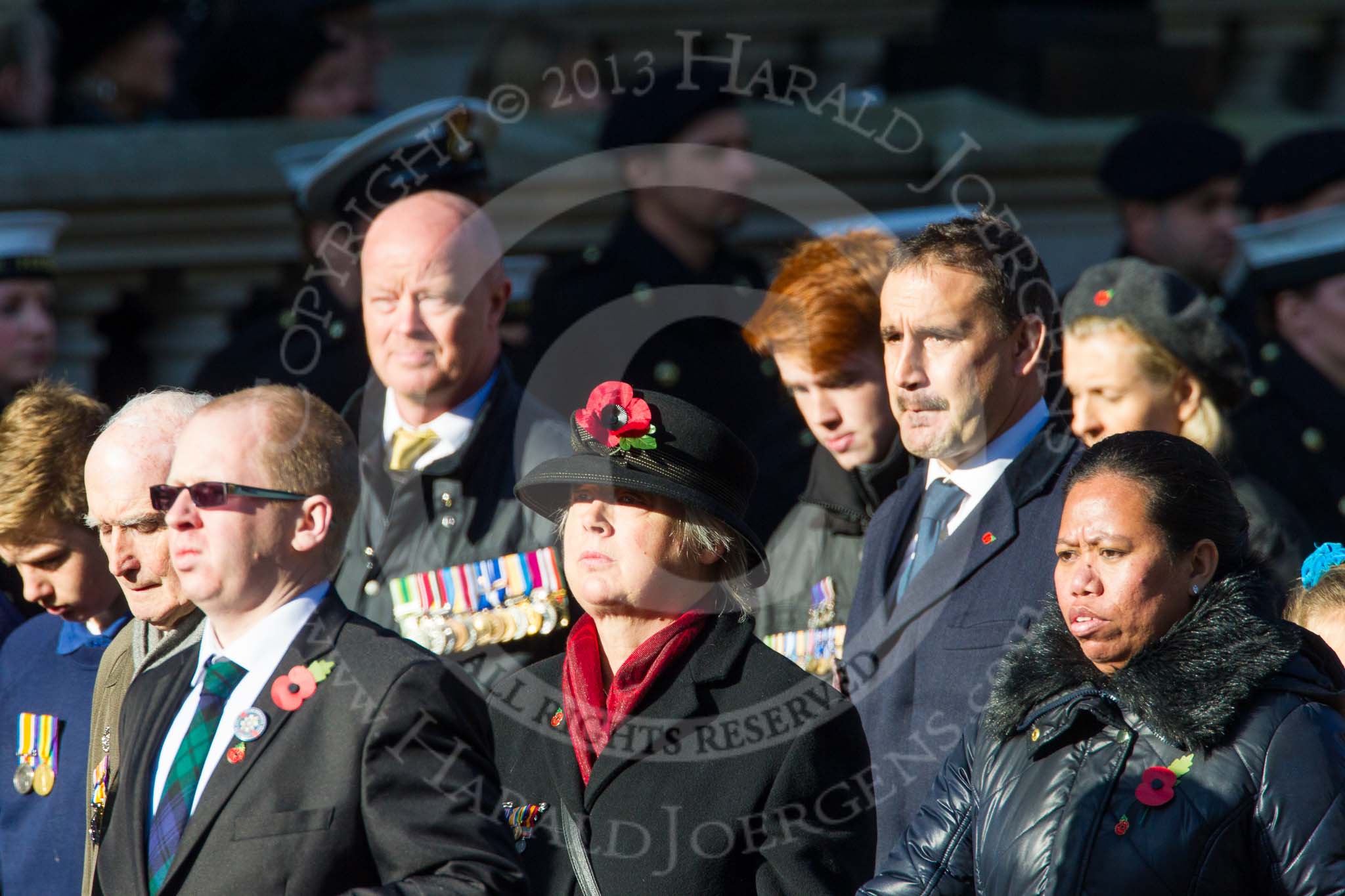 Remembrance Sunday at the Cenotaph in London 2014: Group M23 - Civilians Representing Families.
Press stand opposite the Foreign Office building, Whitehall, London SW1,
London,
Greater London,
United Kingdom,
on 09 November 2014 at 12:18, image #2152