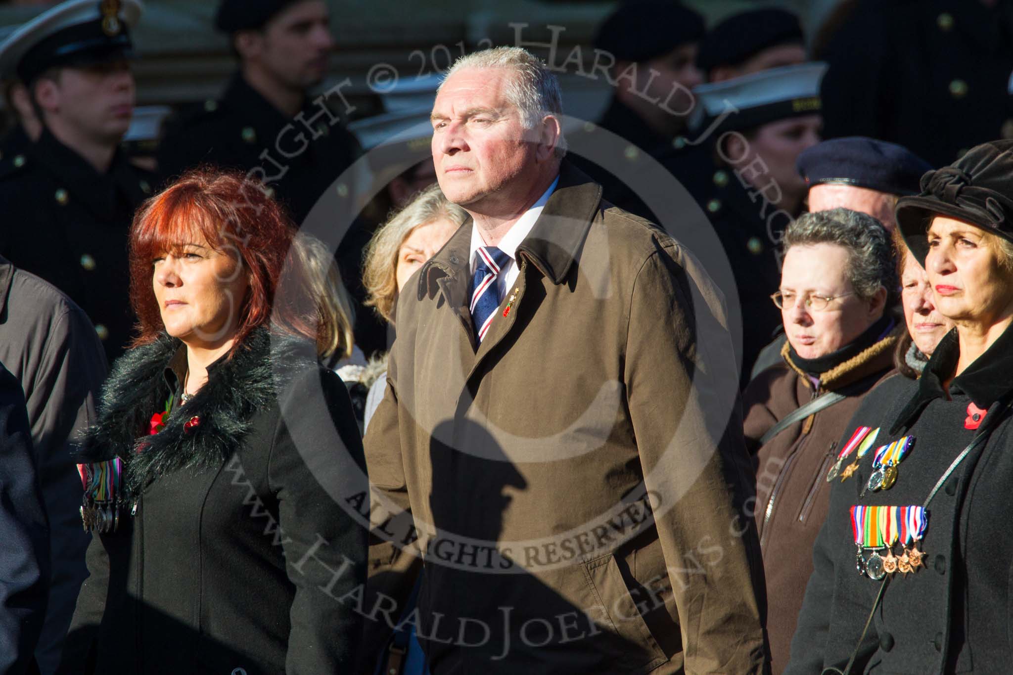 Remembrance Sunday at the Cenotaph in London 2014: Group M23 - Civilians Representing Families.
Press stand opposite the Foreign Office building, Whitehall, London SW1,
London,
Greater London,
United Kingdom,
on 09 November 2014 at 12:18, image #2155