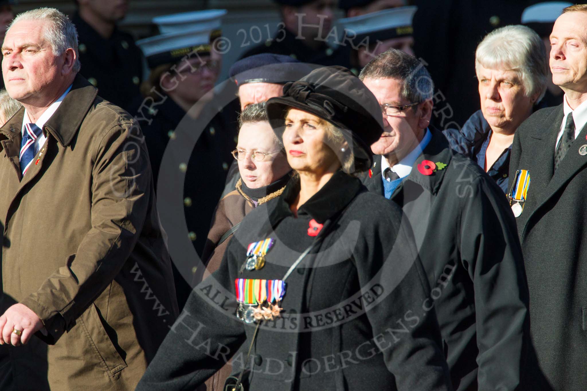 Remembrance Sunday at the Cenotaph in London 2014: Group M23 - Civilians Representing Families.
Press stand opposite the Foreign Office building, Whitehall, London SW1,
London,
Greater London,
United Kingdom,
on 09 November 2014 at 12:18, image #2156