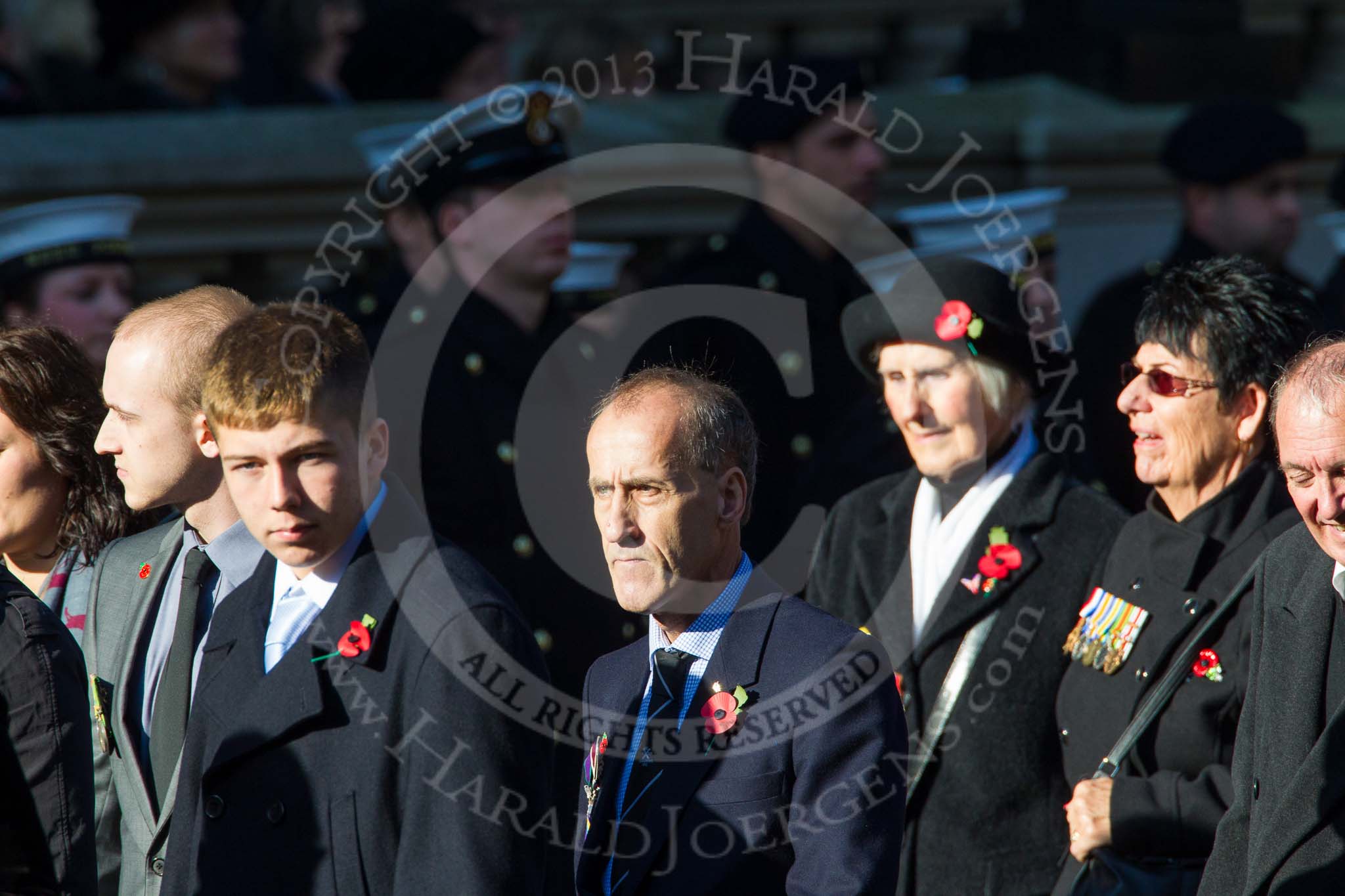Remembrance Sunday at the Cenotaph in London 2014: Group M23 - Civilians Representing Families.
Press stand opposite the Foreign Office building, Whitehall, London SW1,
London,
Greater London,
United Kingdom,
on 09 November 2014 at 12:18, image #2168