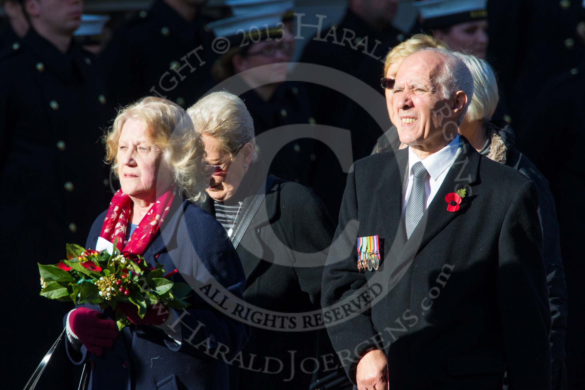 Remembrance Sunday at the Cenotaph in London 2014: Group M23 - Civilians Representing Families.
Press stand opposite the Foreign Office building, Whitehall, London SW1,
London,
Greater London,
United Kingdom,
on 09 November 2014 at 12:18, image #2176
