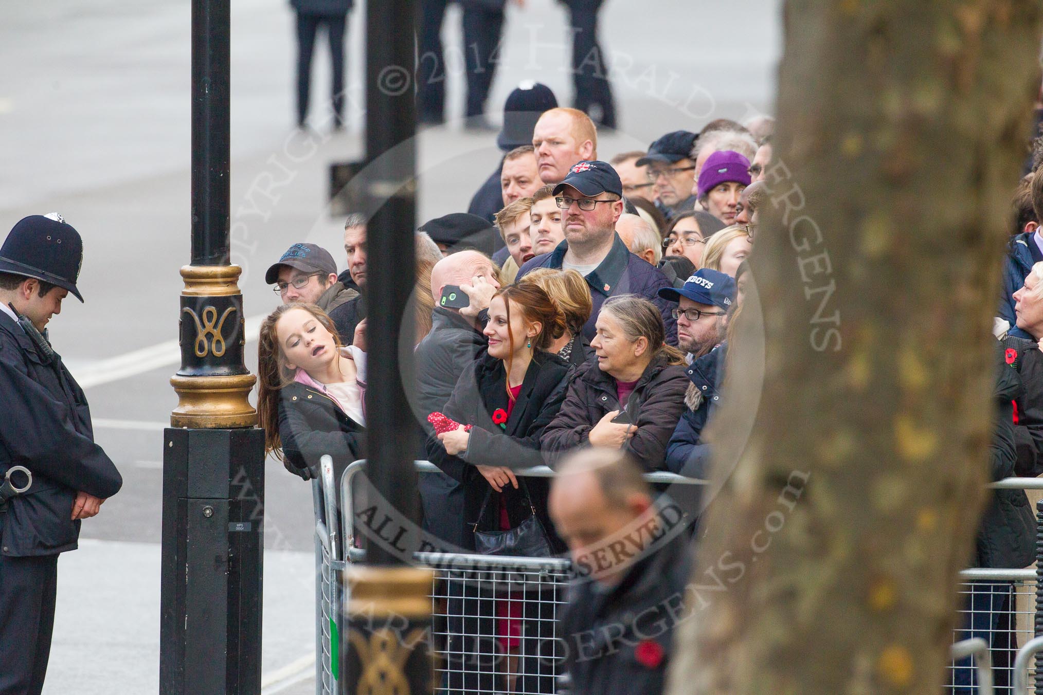 Remembrance Sunday at the Cenotaph in London 2014: Crowds waiting behind barriers at the eastern side of Whitehall..
Press stand opposite the Foreign Office building, Whitehall, London SW1,
London,
Greater London,
United Kingdom,
on 09 November 2014 at 08:13, image #4