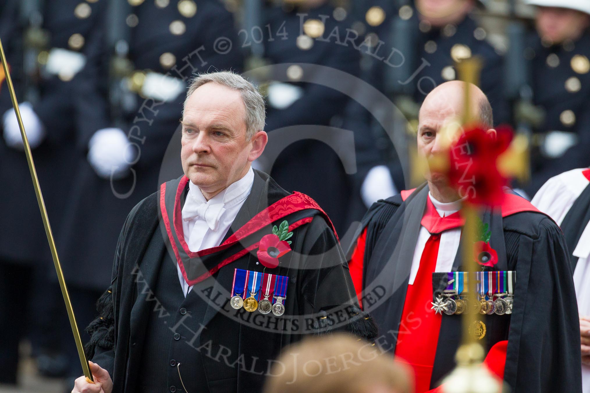 Remembrance Sunday at the Cenotaph in London 2014: The Serjeant of the Vestry, David Baldwin, followed by the Chaplain General to HM Land Forces, Reverend Dr David George Coulter, behind the cross.
Press stand opposite the Foreign Office building, Whitehall, London SW1,
London,
Greater London,
United Kingdom,
on 09 November 2014 at 10:54, image #111