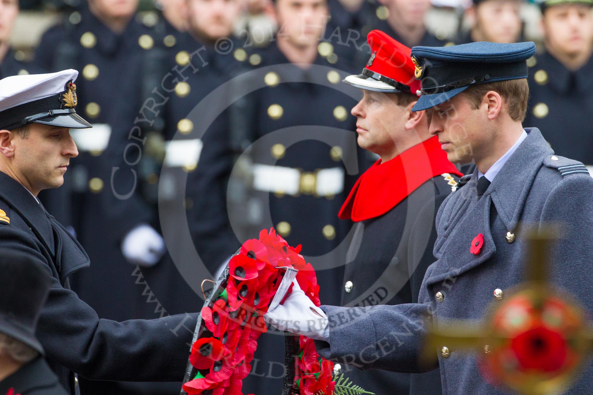 Remembrance Sunday at the Cenotaph in London 2014: Lieutenant James Benbow, Royal Navy, equerry to HRH The Duke of Cambridge, handing over the wreath to Prince William.
Press stand opposite the Foreign Office building, Whitehall, London SW1,
London,
Greater London,
United Kingdom,
on 09 November 2014 at 11:05, image #201
