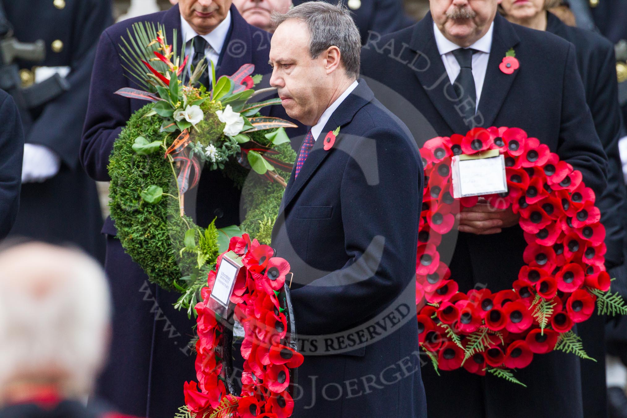 Remembrance Sunday at the Cenotaph in London 2014: The leader of the Democratic Unionist Party, Nigel Dodds, walking towards the Cenotaph with his wreath.
Press stand opposite the Foreign Office building, Whitehall, London SW1,
London,
Greater London,
United Kingdom,
on 09 November 2014 at 11:08, image #229