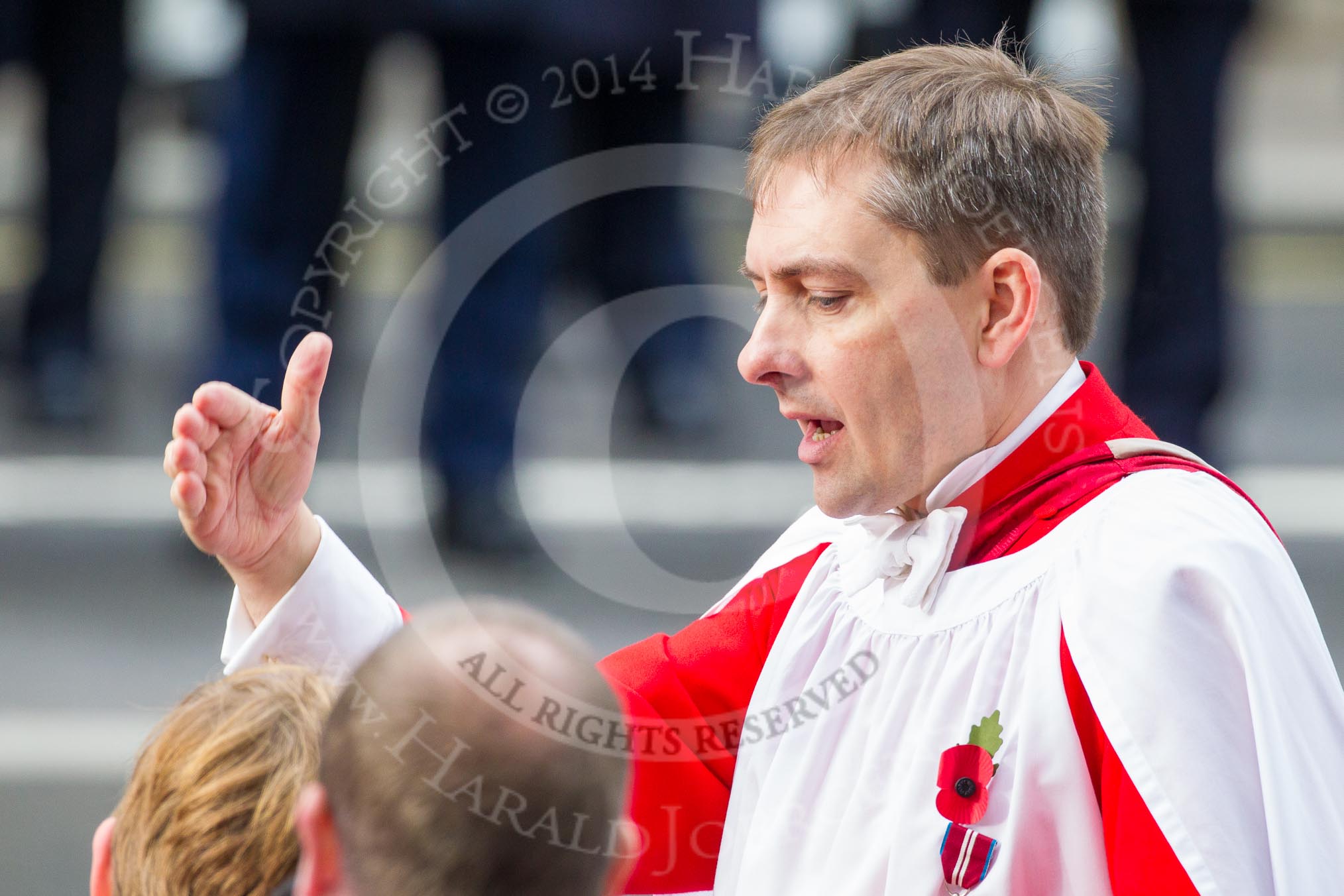 Remembrance Sunday at the Cenotaph in London 2014: Hugh Williams, Director of Music of Her Majesty's Chapel Royal at St James's Palace, conducting the choir during the service.
Press stand opposite the Foreign Office building, Whitehall, London SW1,
London,
Greater London,
United Kingdom,
on 09 November 2014 at 11:16, image #273