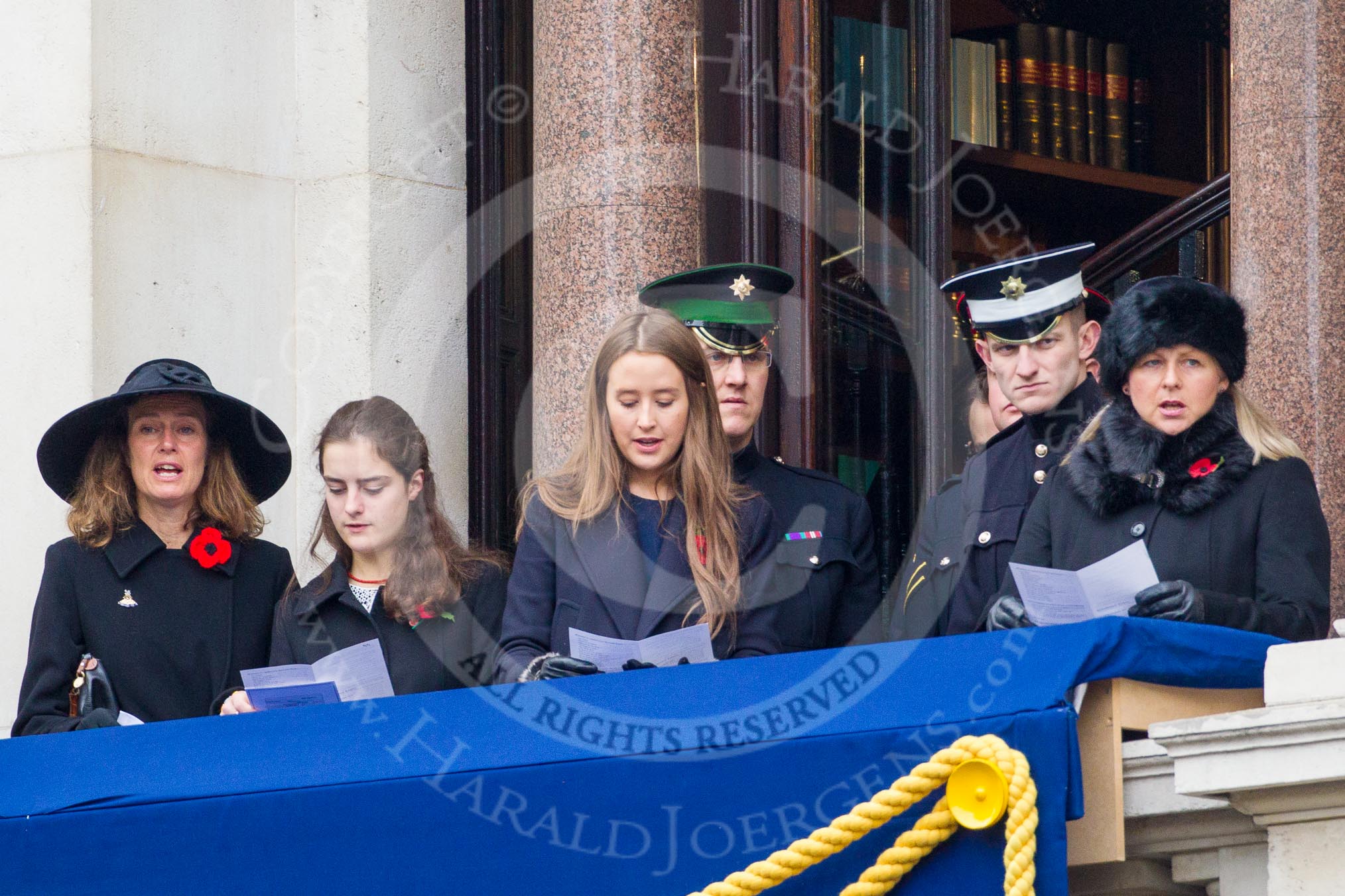 Remembrance Sunday at the Cenotaph in London 2014: Guests singing during the service on one of the balconies of the Foreign- and Commonwealth Office.
Press stand opposite the Foreign Office building, Whitehall, London SW1,
London,
Greater London,
United Kingdom,
on 09 November 2014 at 11:17, image #279