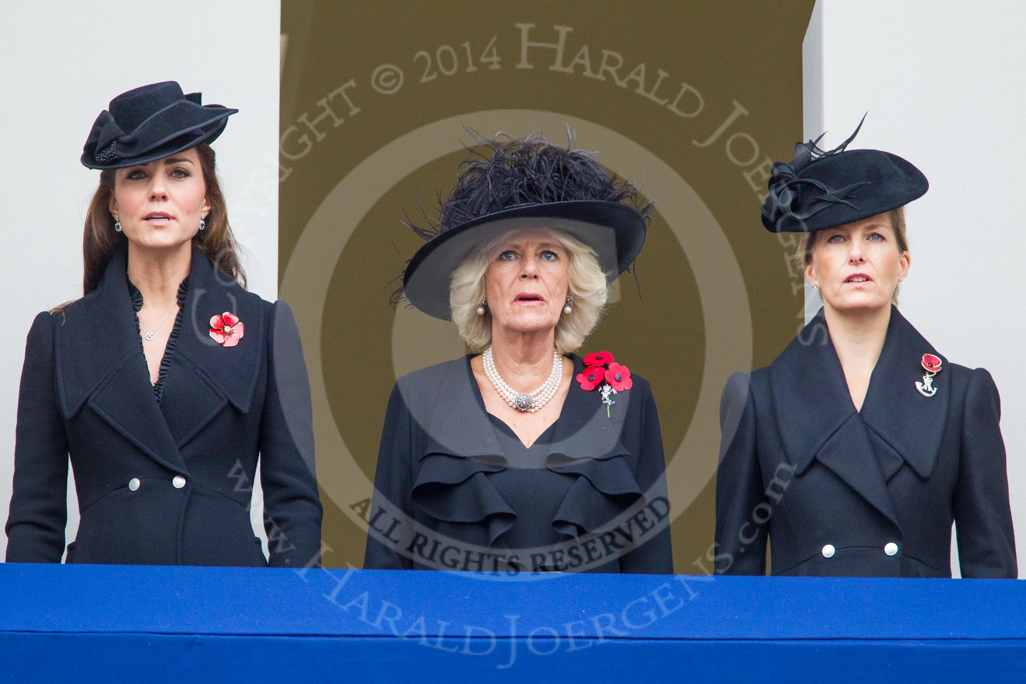 Remembrance Sunday at the Cenotaph in London 2014: TRH The Duchess of Cambridge, TRH The Duchess of Cornwall, and TRH THe Countess of Wessex on the balcony of the Foreign- and Commonweath Office, singung during the service.
Press stand opposite the Foreign Office building, Whitehall, London SW1,
London,
Greater London,
United Kingdom,
on 09 November 2014 at 11:21, image #291