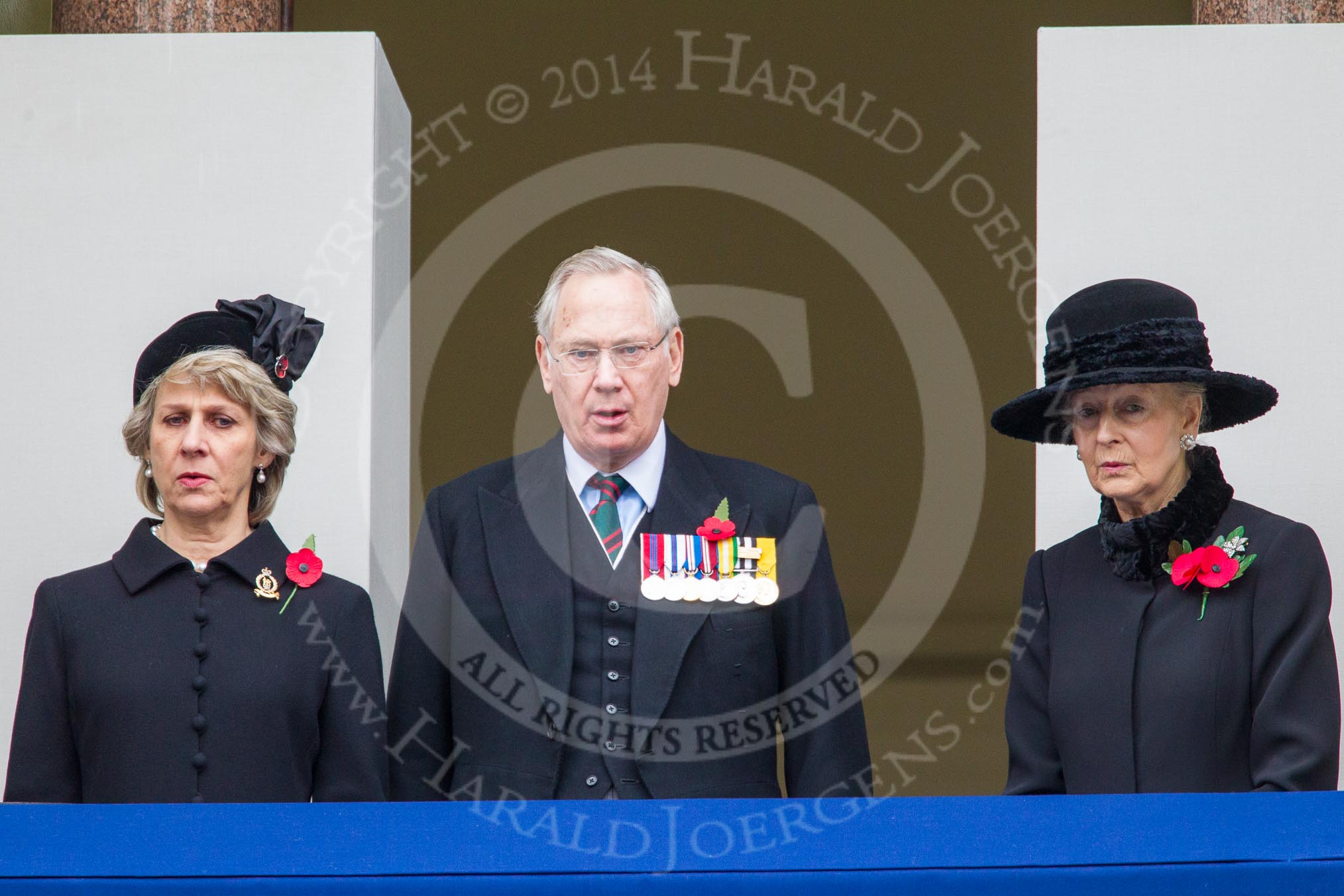 Remembrance Sunday at the Cenotaph in London 2014: THR The Duchess and Duke of Gloucester, and HRH Princess Alexandra, the Hon. Lady Ogilvy, on the centre balcony of the Foreign- and Commonwealth Office building, singing during the service.
Press stand opposite the Foreign Office building, Whitehall, London SW1,
London,
Greater London,
United Kingdom,
on 09 November 2014 at 11:21, image #292